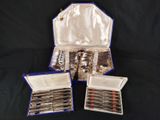 three silverware items are in a case on a black background
