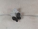 silver bracelet with black and white diamonds on a mannequin torso
