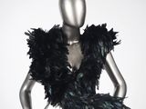a mannequin dressed in a black feathered dress