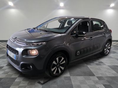 the grey citrole is parked on a checkered tile floor