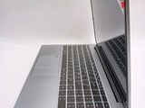 a silver laptop with a black keyboard on a white surface