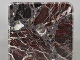 an image of a red and black marble block on a white surface