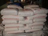 a pile of white pillows on a table in a warehouse
