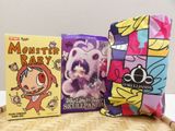 three books and a pillow on the table