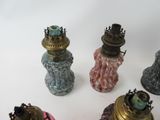 five different colored vases sitting next to each other