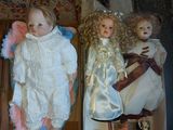 two dolls that are sitting in a box on the floor