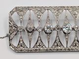 an image of a silver broochle with diamonds on a chain