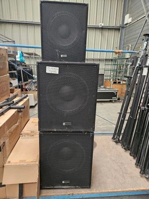 two speakers stacked on top of each other in a warehouse