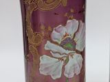 two vases with flowers painted on them sitting next to each other