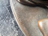 a bronze statue of a woman holding a knife and fork