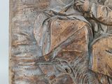 a relief of a man and a woman sitting on a bench
