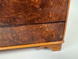 a wooden cabinet with a drawer on top of it