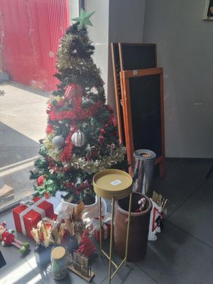 a small christmas tree in the corner of a room next to a window