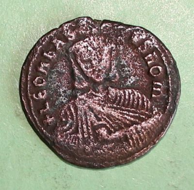 a close up of a coin on a green surface