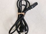 a close up of a black power cord on a white surface