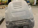 an image of a car in a garage with a floor scruber