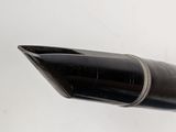 a black pen with a silver tip on a white surface