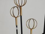 four metal and gold colored objects that are on display