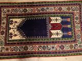 rug on the floor with a blue border and a red border