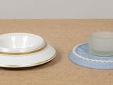 three cups and a saucer on a table
