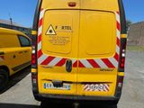 a yellow van that is parked in a parking lot