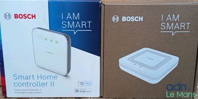 two boxes of bosch smart home controllers sitting on a table