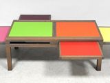 a group of three tables with different colors on them
