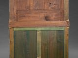 an old wooden cabinet with a glass door on top of it