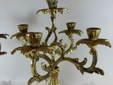 a gold colored candelab with five candles on it