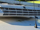 a car that is parked next to a boat on the water