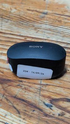a remote control sitting on top of a wooden table