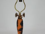 an orange and black table lamp with a deer head on top of it