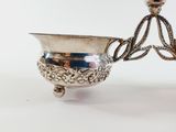 an antique silver plated candle holder on a white background