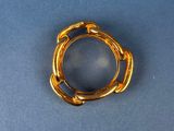 an image of a gold plated ring on a blue surface