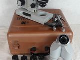 a brown suitcase with a microscope on top of it