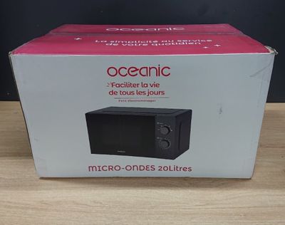 packaging for a microwave on a wooden table with a black background