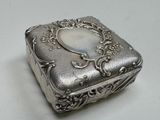 a silver box with a picture on it on a table