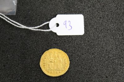 a gold coin with a price tag attached to it