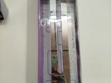 packaging of a purple and white electronic device sitting on top of a white table