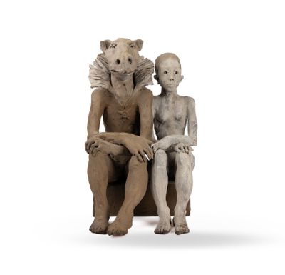 a statue of a man and a woman sitting on a chair
