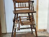 a wooden high chair that is sitting in the corner of a room