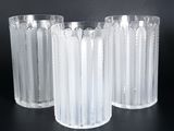 three clear glass vases sitting on top of a black table