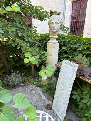 an image of a garden with a statue in the background