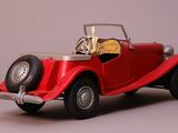 a red toy car that is sitting on a table