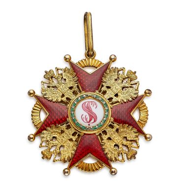 un gros plan d'une médaille rouge et or sur fond blanc