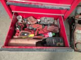 une boîte à outils rouge avec des outils sur le sol