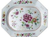 a plate with flowers on it on a white background