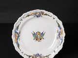 an image of a white plate with blue and yellow flowers on it