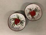 two small plates with designs on them on a table