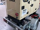 a small generator on a trailer in a warehouse